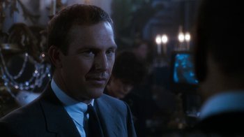 Movie still from “The Bodyguard” (1992), directed by Mick Jackson – A man in a suit and tie; Close Up shot, Over the shoulder angle