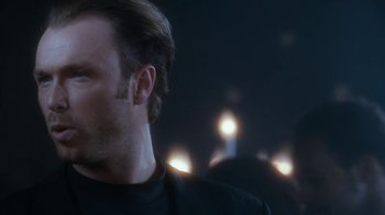 Movie still from “The Bodyguard” (1992), directed by Mick Jackson – A man's face in the dark; Close Up shot, Over the shoulder angle