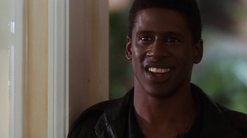 Movie still from “The Bodyguard” (1992), directed by Mick Jackson – A person with a smile on their face; Close Up shot, Over the shoulder angle