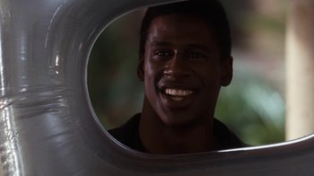 Movie still from “The Bodyguard” (1992), directed by Mick Jackson – A person looking at their reflection in a mirror; Close Up shot, Over the shoulder angle