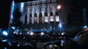 Movie still from “The Bodyguard” (1992), directed by Mick Jackson – A night view of a building with a lot of lights on it; Extreme Wide shot, Low angle