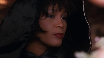 Movie still from “The Bodyguard” (1992), directed by Mick Jackson – A person wearing a black jacket; Close Up shot, Over the shoulder angle