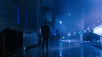 Movie still from “The Bodyguard” (1992), directed by Mick Jackson – A man is walking down the street at night; Wide shot, Low angle