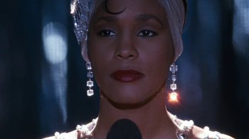 Movie still from “The Bodyguard” (1992), directed by Mick Jackson – A person with a microphone; Close Up shot, Low angle