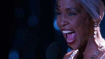 Movie still from “The Bodyguard” (1992), directed by Mick Jackson – A person singing on a microphone; Close Up shot, Low angle