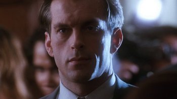 Movie still from “The Bodyguard” (1992), directed by Mick Jackson – A man in a suit and tie; Close Up shot, Low angle