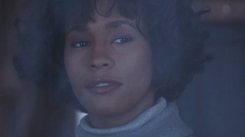 Movie still from “The Bodyguard” (1992), directed by Mick Jackson – A person wearing a sweater; Close Up shot, Over the shoulder angle
