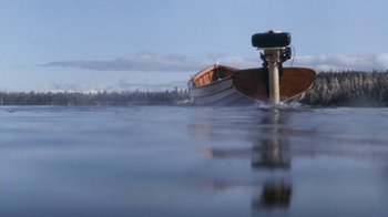 Movie still from “The Bodyguard” (1992), directed by Mick Jackson – A motor boat in a body of water; Extreme Wide shot, Low angle