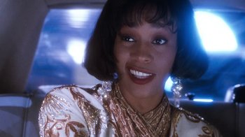 Movie still from “The Bodyguard” (1992), directed by Mick Jackson – A person wearing a dress; Close Up shot, Over the shoulder angle