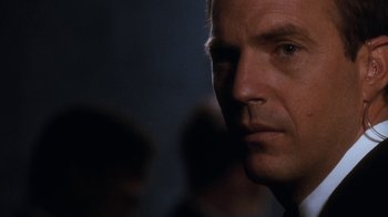 Movie still from “The Bodyguard” (1992), directed by Mick Jackson – A man's face in the dark; Close Up shot, Over the shoulder angle