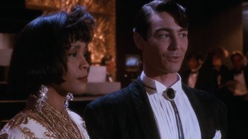 Movie still from “The Bodyguard” (1992), directed by Mick Jackson – A man and a woman standing next to each other; Close Up shot, Low angle