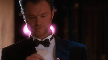 Movie still from “The Bodyguard” (1992), directed by Mick Jackson – A person wearing a suit and bow tie; Close Up shot, Low angle