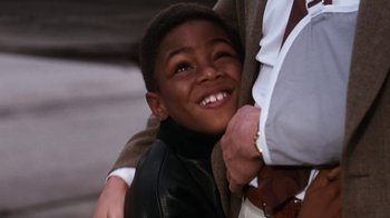Movie still from “The Bodyguard” (1992), directed by Mick Jackson – A person with a child; Close Up shot, High angle