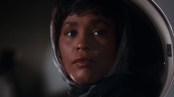 Movie still from “The Bodyguard” (1992), directed by Mick Jackson – A person wearing a hood; Close Up shot, Low angle