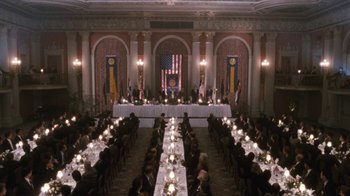 Movie still from “The Bodyguard” (1992), directed by Mick Jackson – A banquet hall with people sitting at long tables; Extreme Wide shot, High angle