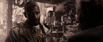 Movie still from “The Book of Eli” (2010), directed by Allen Hughes – A man with a beard is standing in a room; Close Up shot, Over the shoulder angle
