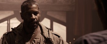 Movie still from “The Book of Eli” (2010), directed by Allen Hughes – A man with a beard is standing in a room; Close Up shot, Over the shoulder angle