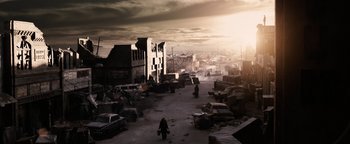 Movie still from “The Book of Eli” (2010), directed by Allen Hughes – An image of a city with a person walking in it; Extreme Wide shot, High angle