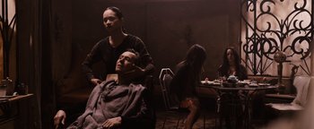 Movie still from “The Book of Eli” (2010), directed by Allen Hughes – A man getting his hair combed by a woman; Medium shot, Over the shoulder angle