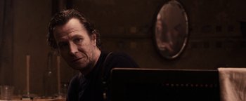 Movie still from “The Book of Eli” (2010), directed by Allen Hughes – A man sitting in front of a laptop computer in front of a mirror; Close Up shot, Over the shoulder angle