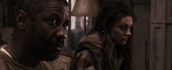 Movie still from “The Book of Eli” (2010), directed by Allen Hughes – A man and a woman sitting next to each other in a room; Close Up shot, Over the shoulder angle