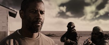 Movie still from “The Book of Eli” (2010), directed by Allen Hughes – A man standing next to another man on a beach; Close Up shot, Over the shoulder angle