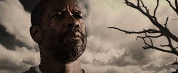 Movie still from “The Book of Eli” (2010), directed by Allen Hughes – A person with a bird flying in the background; Close Up shot, Low angle