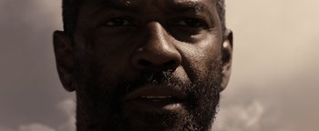 Movie still from “The Book of Eli” (2010), directed by Allen Hughes – A man with a beard looking into the distance; Extreme Close Up shot, High angle
