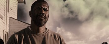 Movie still from “The Book of Eli” (2010), directed by Allen Hughes – A person with a cloudy sky in the background; Close Up shot, Low angle