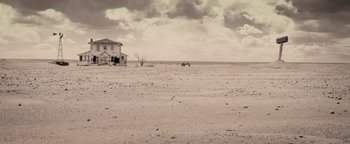 Movie still from “The Book of Eli” (2010), directed by Allen Hughes – An abandoned house in the middle of a desert; Extreme Wide shot, High angle
