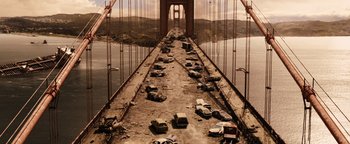 Movie still from “The Book of Eli” (2010), directed by Allen Hughes – Cars are parked on a bridge over a river; Extreme Wide shot, High angle