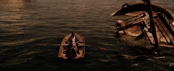 Movie still from “The Book of Eli” (2010), directed by Allen Hughes – A man rowing a boat in the middle of the ocean; Extreme Wide shot, High angle