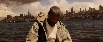 Movie still from “The Book of Eli” (2010), directed by Allen Hughes – A man with a beard is standing in front of a body of water; Medium shot, High angle