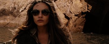 Movie still from “The Book of Eli” (2010), directed by Allen Hughes – A person wearing sunglasses near a rock formation; Close Up shot, Over the shoulder angle