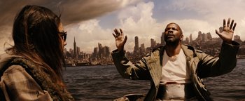 Movie still from “The Book of Eli” (2010), directed by Allen Hughes – A man standing in front of a body of water; Medium shot, Low angle