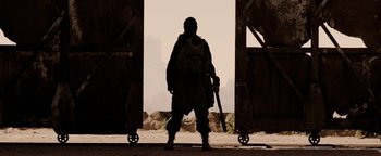 Movie still from “The Book of Eli” (2010), directed by Allen Hughes – A soldier standing in front of an open door; Wide shot, Low angle