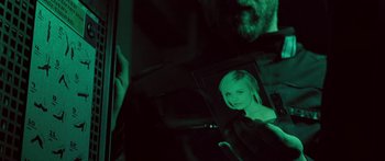 Movie still from “Pandorum” (2009), directed by Christian Alvart – A person holding a picture of a girl; Extreme Close Up shot, Over the shoulder angle