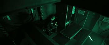 Movie still from “Pandorum” (2009), directed by Christian Alvart – A person sitting on a chair in a room; Wide shot, High angle