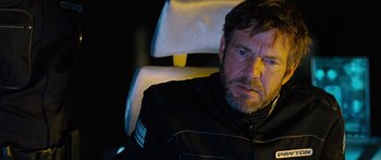 Movie still from “Pandorum” (2009), directed by Christian Alvart – A person sitting in a chair; Close Up shot, Over the shoulder angle