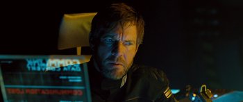 Movie still from “Pandorum” (2009), directed by Christian Alvart – A person sitting in a chair; Close Up shot, Over the shoulder angle