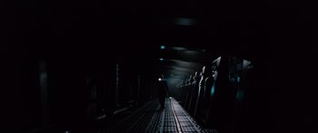 Movie still from “Pandorum” (2009), directed by Christian Alvart – A man standing on a train track at night; Extreme Wide shot, Low angle