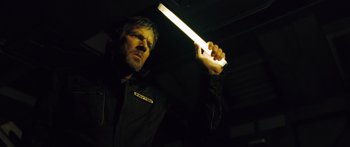 Movie still from “Pandorum” (2009), directed by Christian Alvart – A man is holding a flashlight in the dark; Close Up shot, Low angle
