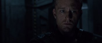 Movie still from “Pandorum” (2009), directed by Christian Alvart – A man's face in the dark; Close Up shot, Low angle
