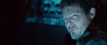 Movie still from “Pandorum” (2009), directed by Christian Alvart – A man's face in the dark; Close Up shot, Over the shoulder angle