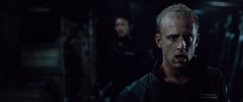 Movie still from “Pandorum” (2009), directed by Christian Alvart – A person in a dark room; Close Up shot, Over the shoulder angle