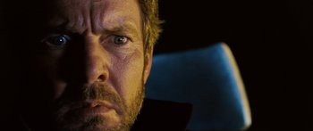 Movie still from “Pandorum” (2009), directed by Christian Alvart – A man's face in a car; Extreme Close Up shot, Low angle