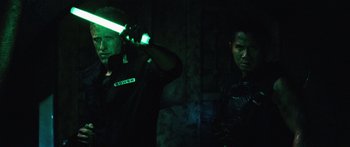 Movie still from “Pandorum” (2009), directed by Christian Alvart – Two men are standing in a dark room; Medium shot, Over the shoulder angle