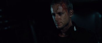 Movie still from “Pandorum” (2009), directed by Christian Alvart – A person with blood on his face; Close Up shot, Over the shoulder angle