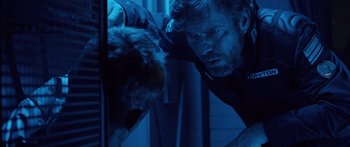 Movie still from “Pandorum” (2009), directed by Christian Alvart – A man with a beard is looking at a cat; Close Up shot, Low angle