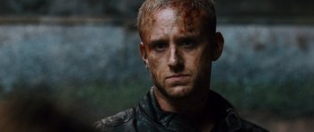 Movie still from “Pandorum” (2009), directed by Christian Alvart – A person wearing a leather jacket; Close Up shot, Over the shoulder angle